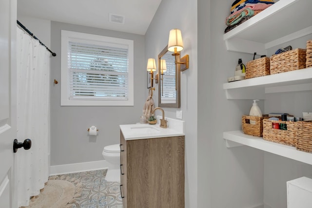 bathroom with vanity, toilet, and tile patterned flooring