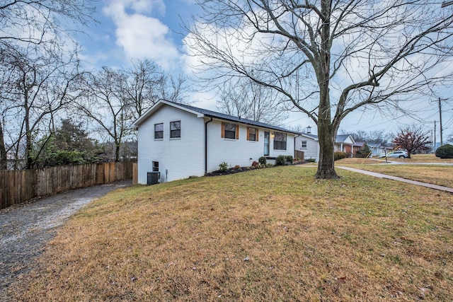 view of side of home with a yard and cooling unit