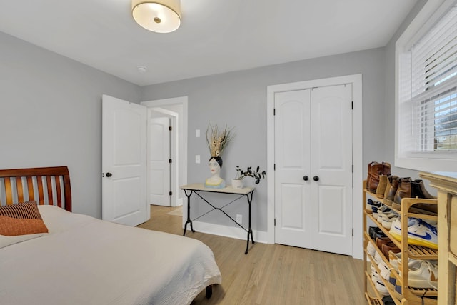 bedroom with a closet and light hardwood / wood-style flooring