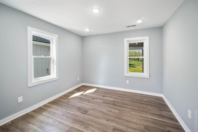 empty room with hardwood / wood-style floors