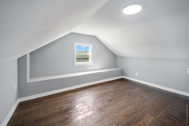 additional living space with lofted ceiling and dark hardwood / wood-style flooring