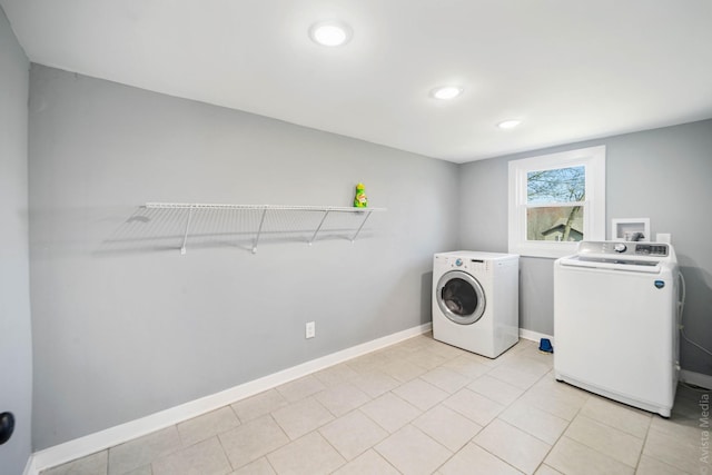 laundry area featuring light tile patterned floors and independent washer and dryer