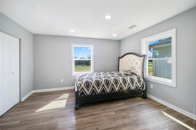 bedroom with dark wood-type flooring