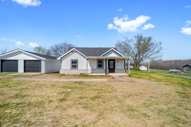 ranch-style house with a garage, a front yard, and covered porch