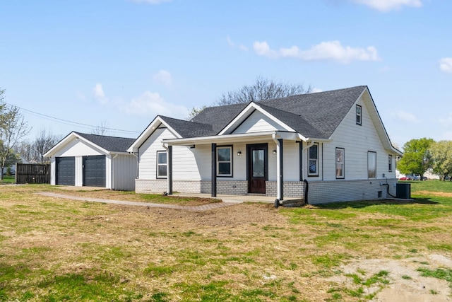 view of front facade featuring a garage, a front yard, and central air condition unit