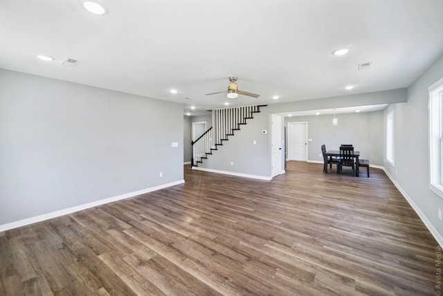 unfurnished living room with wood-type flooring and ceiling fan