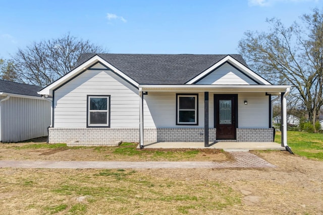 view of front of property with covered porch and a front yard