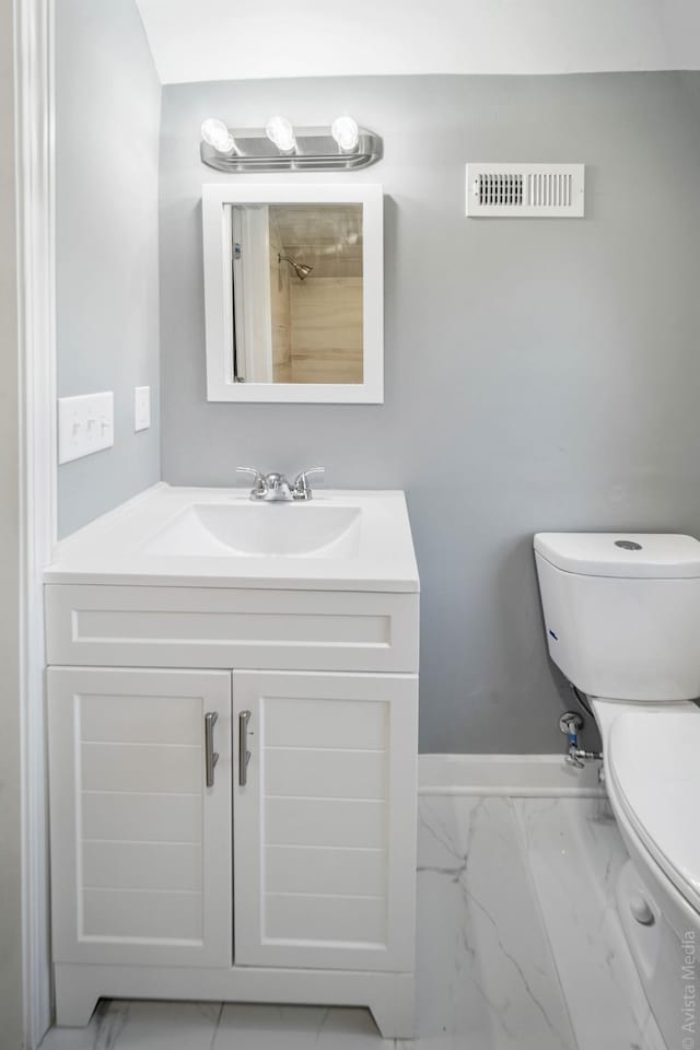 bathroom featuring vanity and toilet