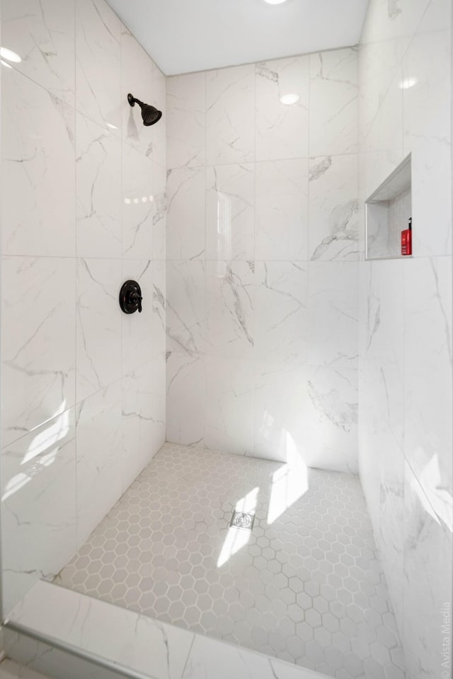 bathroom with a tile shower