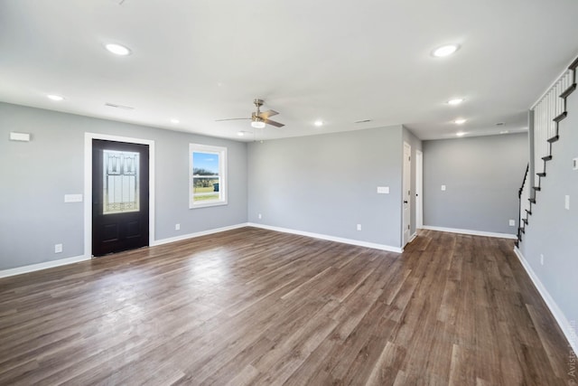 unfurnished living room featuring dark hardwood / wood-style floors and ceiling fan