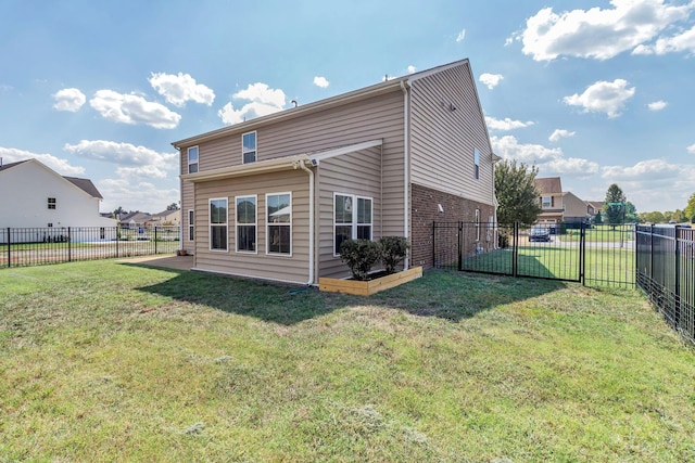 rear view of property with a yard