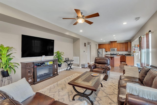 living room with light colored carpet and ceiling fan