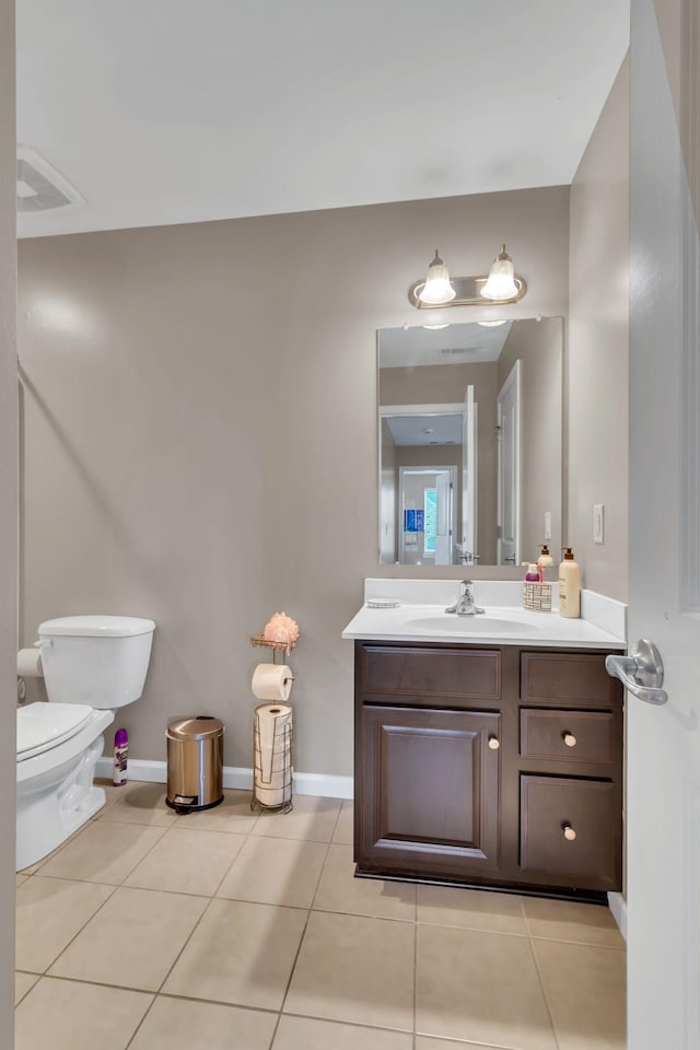 bathroom featuring vanity, toilet, and tile patterned flooring