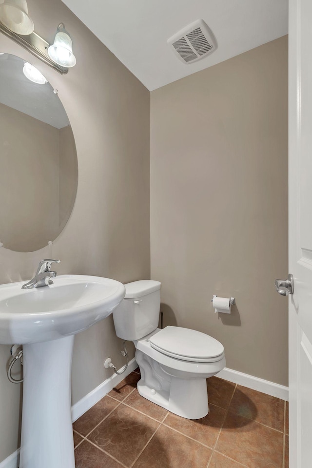 bathroom with sink, tile patterned floors, and toilet