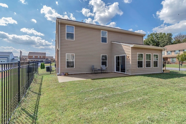 back of property featuring a yard and a patio area