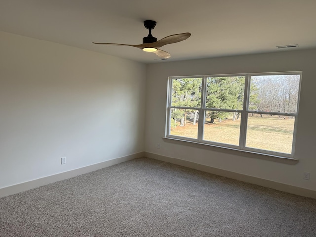 unfurnished room featuring ceiling fan and carpet flooring