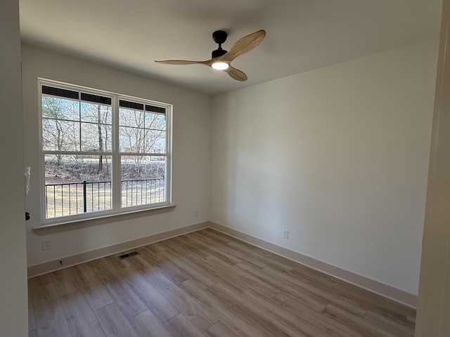 spare room featuring light hardwood / wood-style floors and ceiling fan