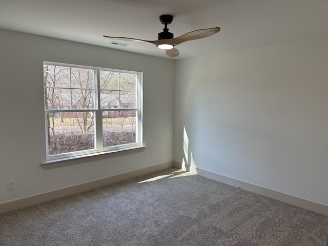 empty room featuring carpet floors and ceiling fan