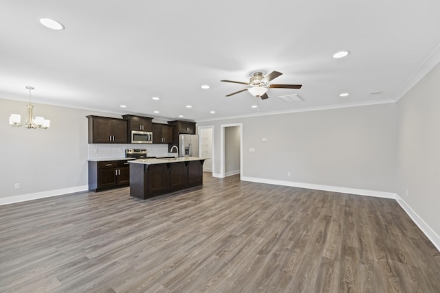 kitchen with appliances with stainless steel finishes, decorative light fixtures, backsplash, hardwood / wood-style flooring, and ornamental molding