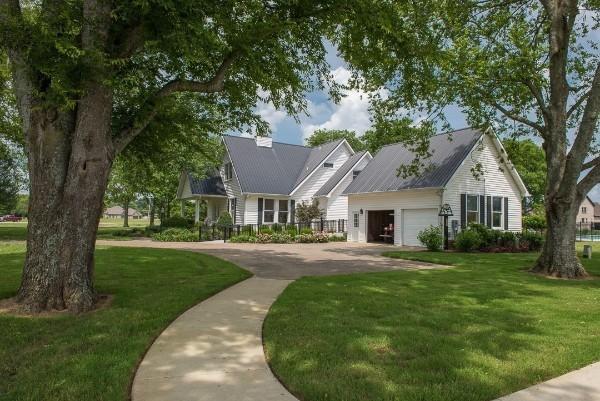 view of front of property with a garage and a front lawn