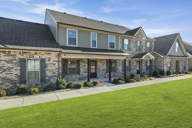 view of front of home with a porch and a front lawn