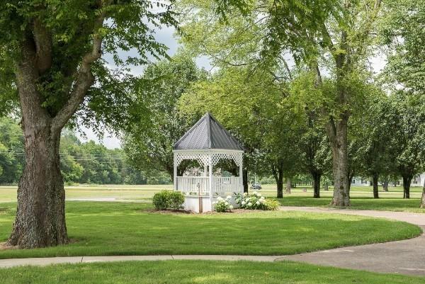 surrounding community with a gazebo and a lawn