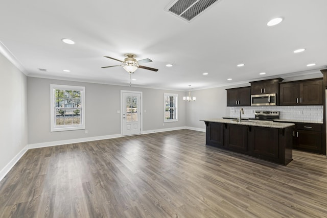 kitchen with crown molding, appliances with stainless steel finishes, and a wealth of natural light