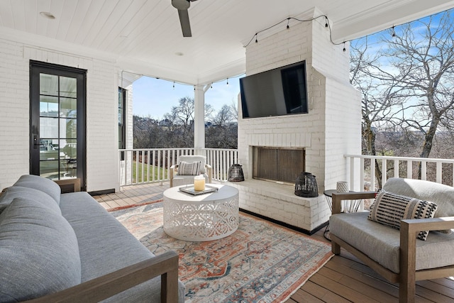 exterior space featuring wood ceiling, hardwood / wood-style flooring, an outdoor brick fireplace, ornamental molding, and brick wall