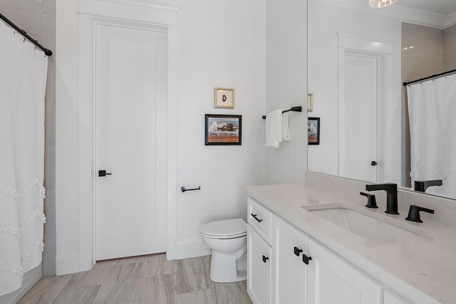 bathroom featuring vanity, walk in shower, and toilet