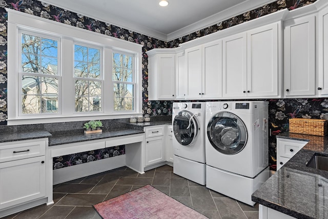 washroom featuring cabinets, ornamental molding, and washer and clothes dryer