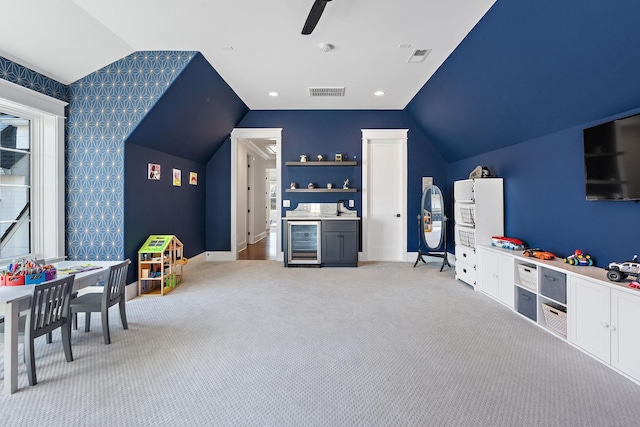 game room with lofted ceiling, wine cooler, light carpet, and ceiling fan