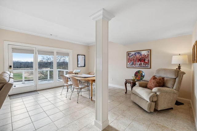 interior space featuring light tile patterned floors, ornamental molding, decorative columns, and baseboards