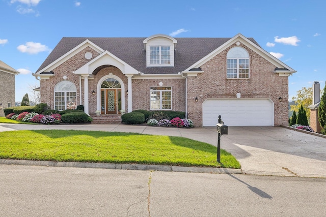 view of front property featuring a garage and a front lawn