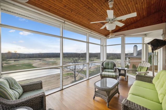 sunroom with wood ceiling, a wealth of natural light, ceiling fan, and vaulted ceiling