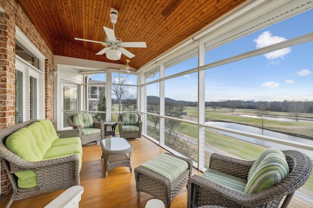 sunroom with wood ceiling, vaulted ceiling, and ceiling fan