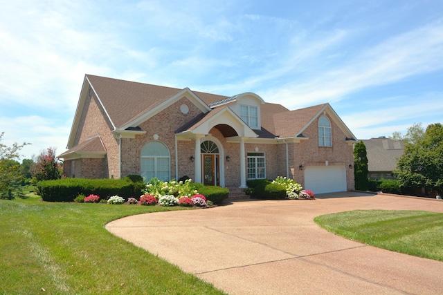 view of front of house featuring a garage and a front yard