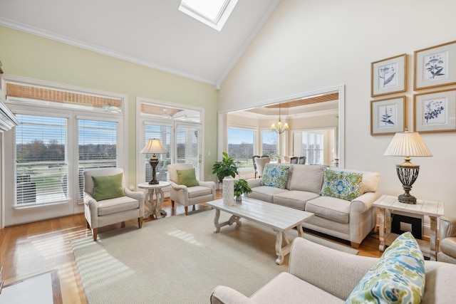 living room featuring crown molding, a skylight, hardwood / wood-style floors, and a notable chandelier