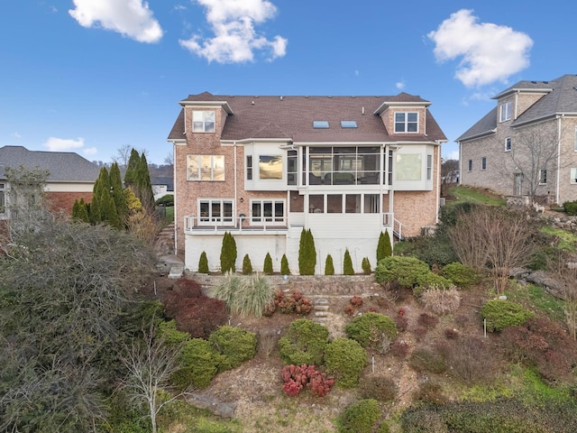 rear view of property with a sunroom