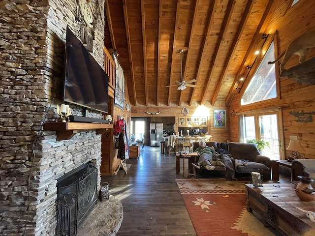 living room with a stone fireplace, wooden walls, dark wood-style flooring, wood ceiling, and beam ceiling