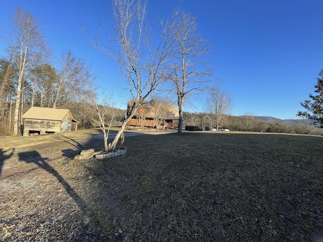 view of yard with a barn and an outdoor structure