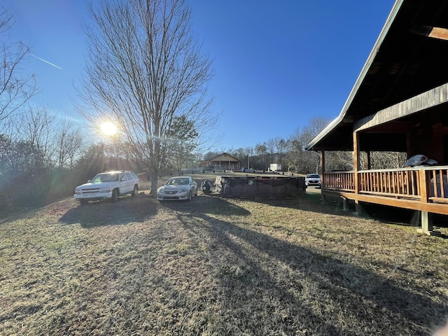 view of yard with a swimming pool side deck