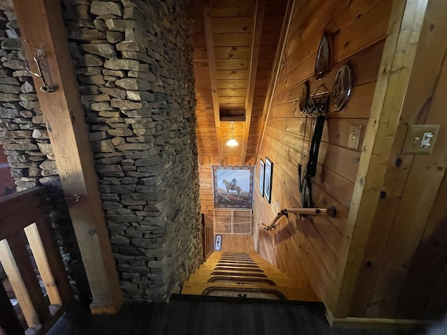 hallway featuring wooden walls