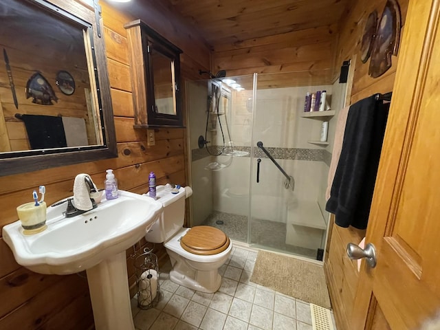 full bathroom with a stall shower, wooden walls, toilet, wood ceiling, and tile patterned flooring