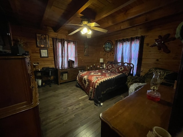 bedroom with beamed ceiling, wood-type flooring, wooden walls, and multiple windows