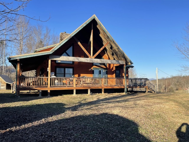 log cabin with a chimney and a front yard