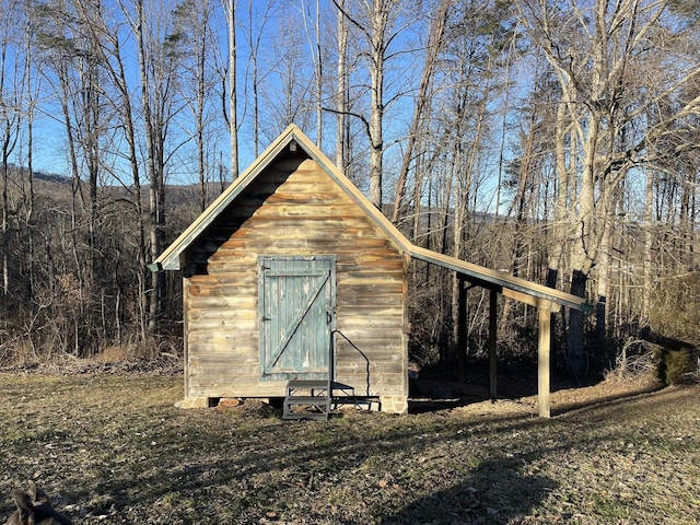 view of shed with a forest view