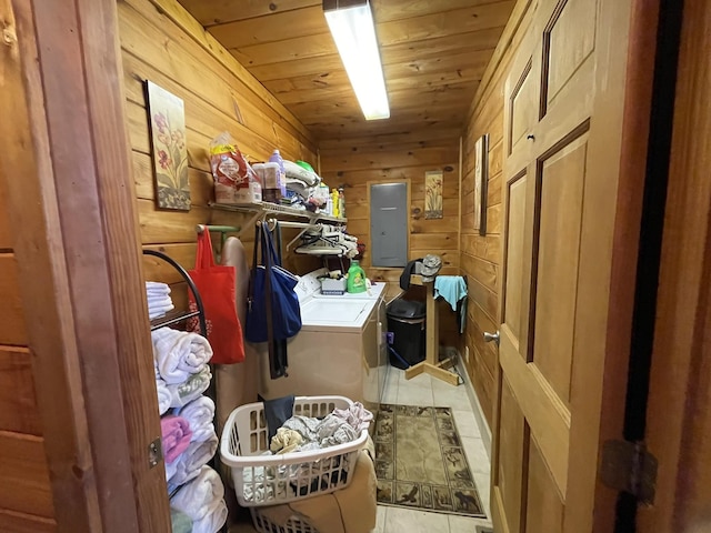 laundry area featuring laundry area, electric panel, wooden ceiling, washing machine and clothes dryer, and wood walls