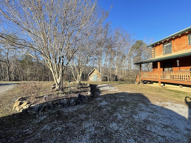 view of yard with an outbuilding and a deck