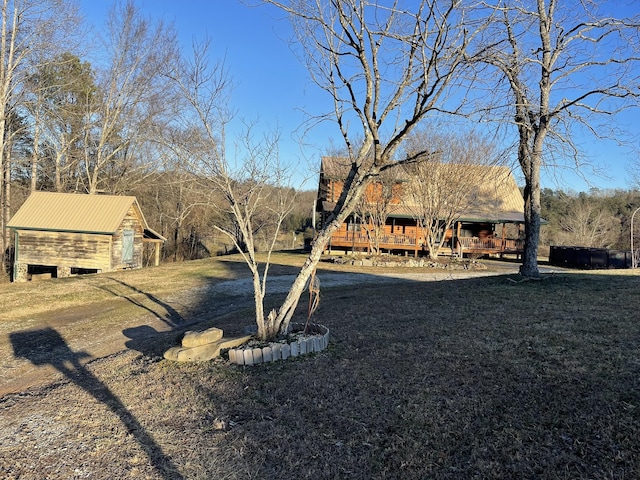 view of yard with a deck and an outbuilding