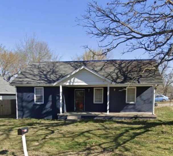 view of front of property with a porch and a front lawn